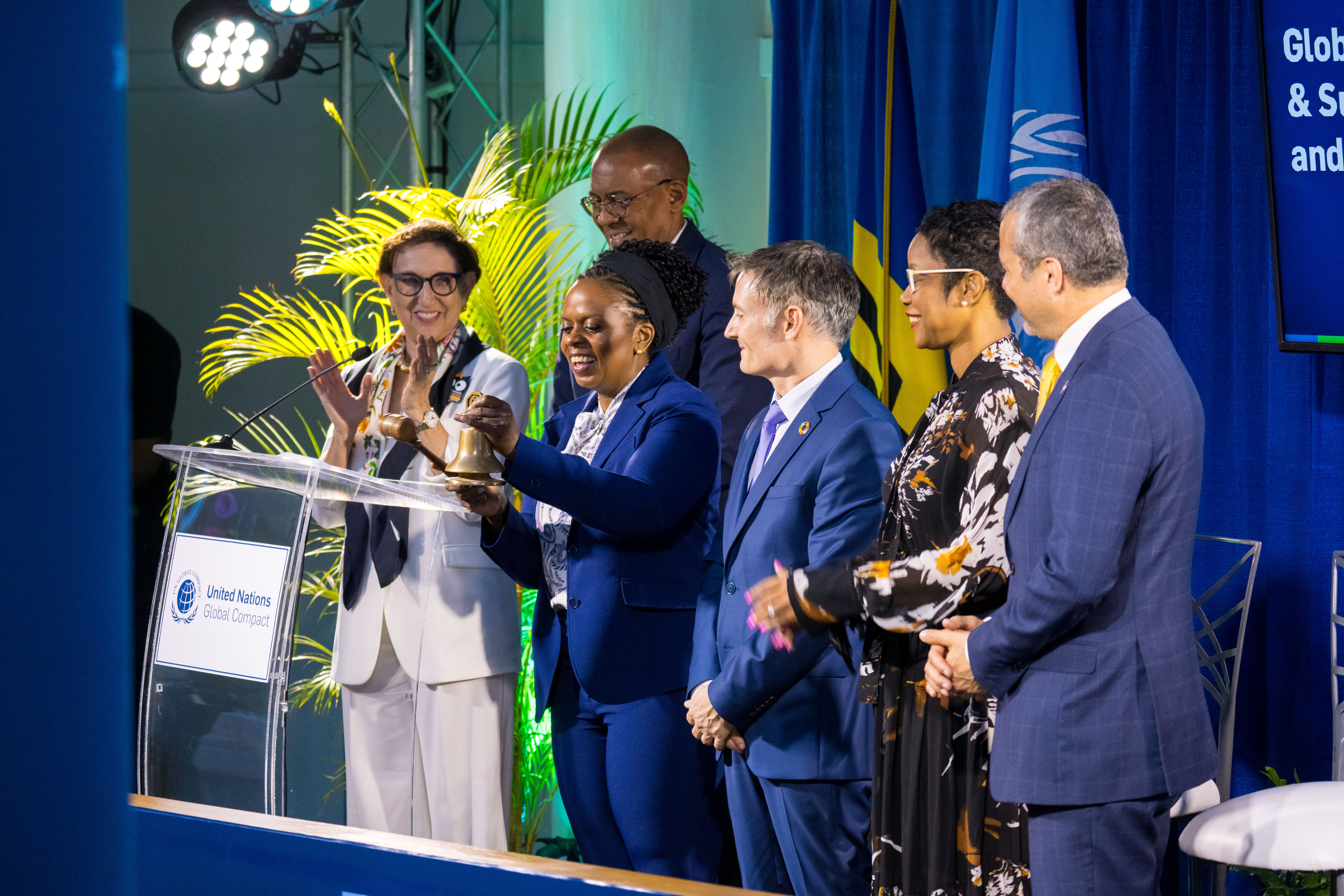 ringing the bell to celebrate the launch of the global comapct Caribbean Network
