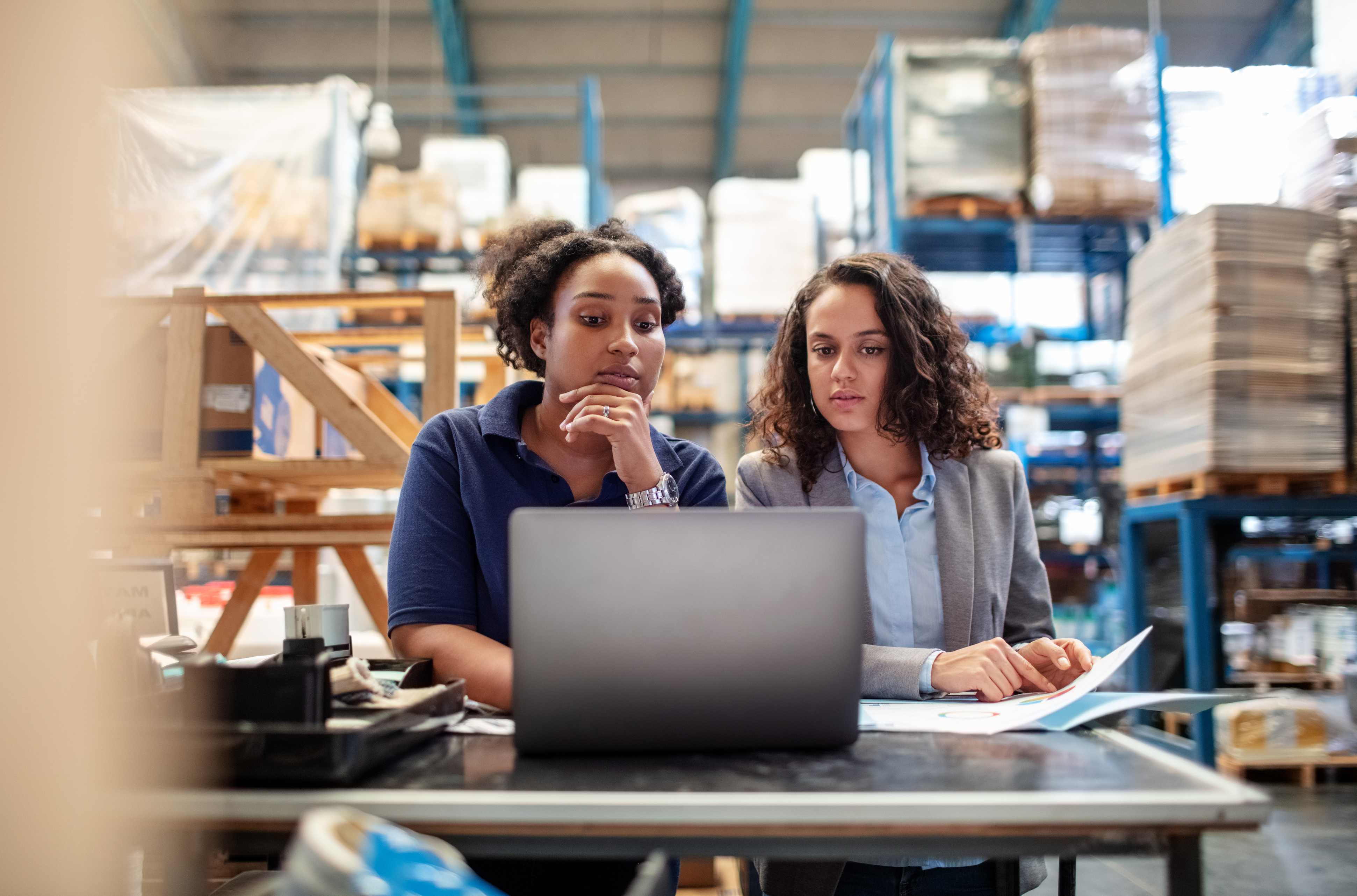 Women talking at their laptop