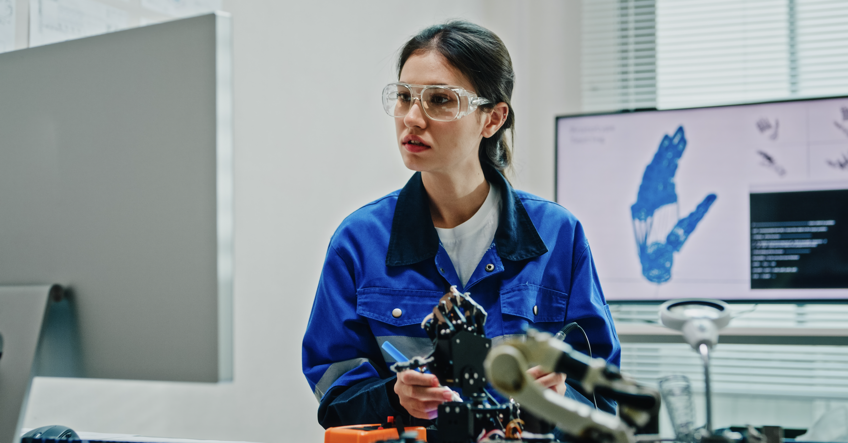 Scientist looking at a model of a hand