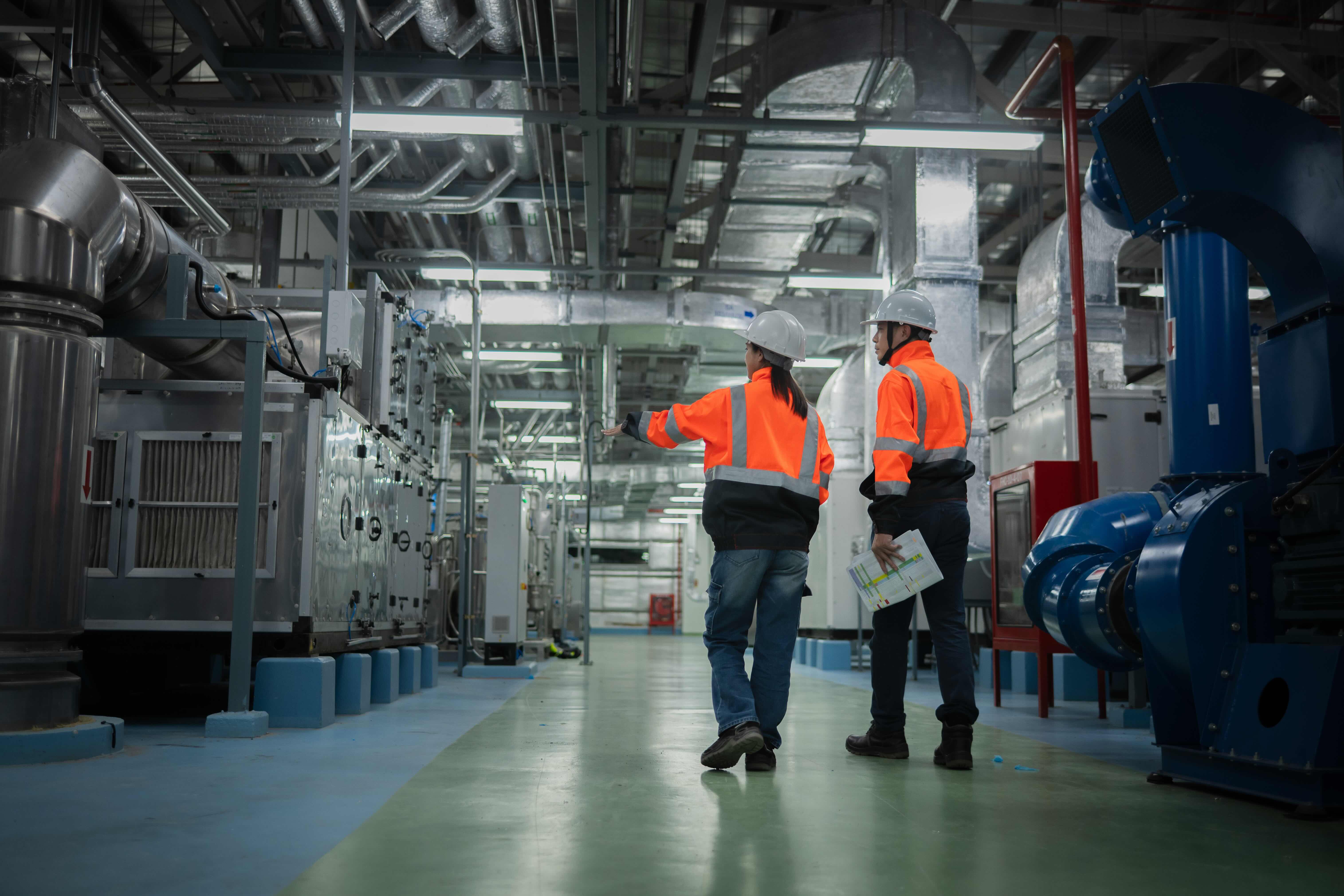 people walking through factory