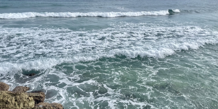 ocean surf crashing on rocks