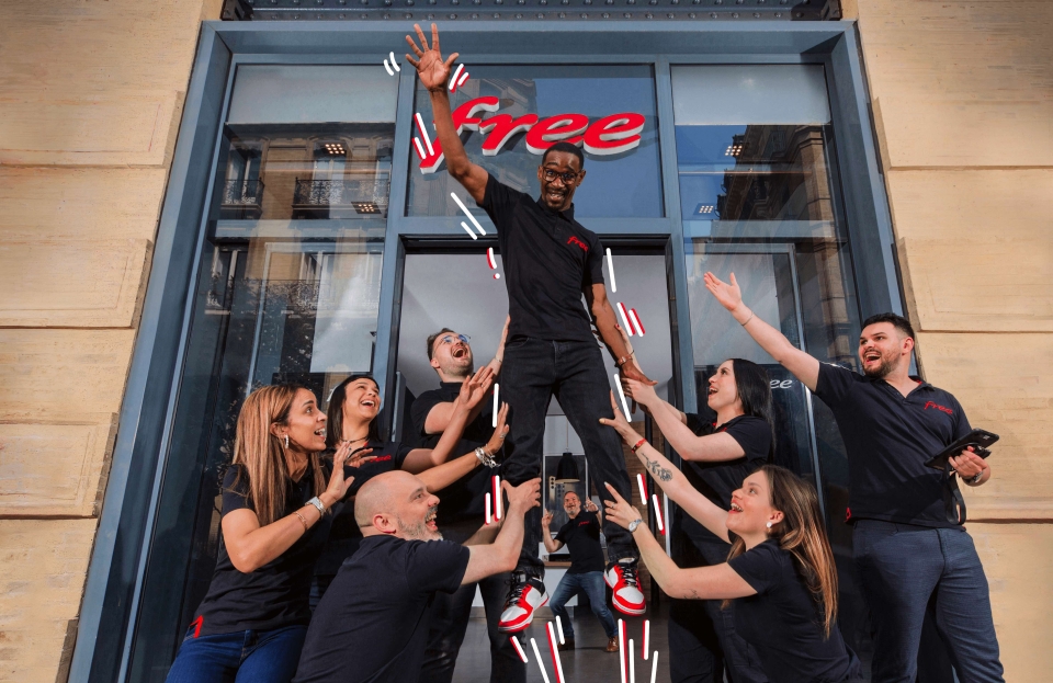 A man raising his right hand in front of a group of people